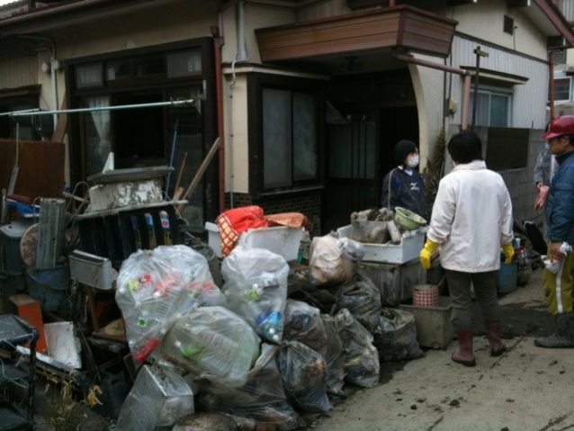 泥出しや清掃作業が終わったあとのごみや瓦礫の山、石巻市 写真:パタゴニア日本支社